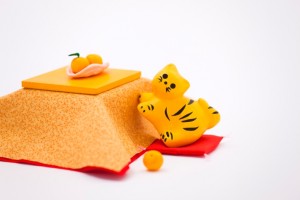 Toy tiger next to kotatsu with mandarins