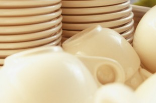 Stacks of clean dishes in restaurant, close-up