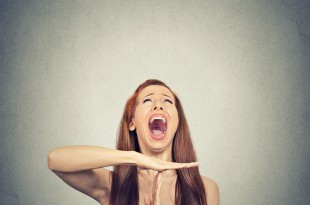 Young woman showing time out hand gesture, frustrated screaming