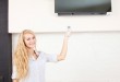 Female holding a remote control air conditioner