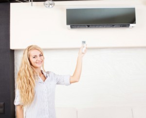 Female holding a remote control air conditioner