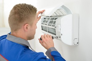 Technician Repairing Air Conditioner