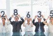 Group of panel judges holding score signs